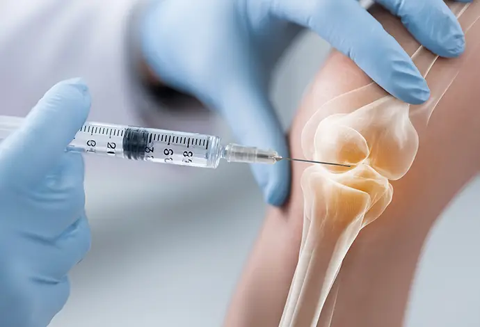 clinician injecting platelet-rich plasma into a knee, highlights minimally invasive regenerative therapy for joint pain and cartilage healing